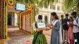 A humanoid robot named Nila dressed in a saree welcoming voters at a polling station
